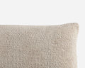 Textured beige pillow on a light gray background
