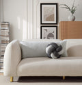 Beige sofa with decorative pillows in a living room setting