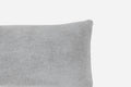 Gray textured pillow on a light gray background