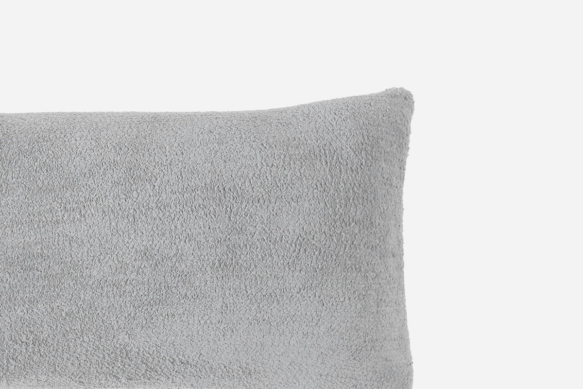Gray textured pillow on a light gray background